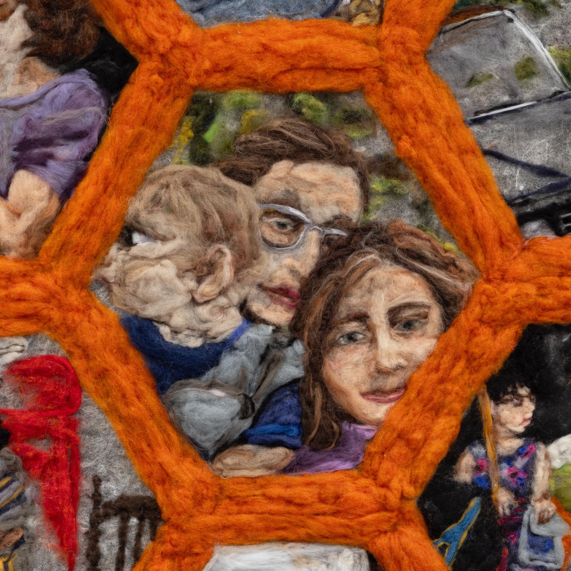 Detail of felted artwork showing a family framed in an orange hexagon