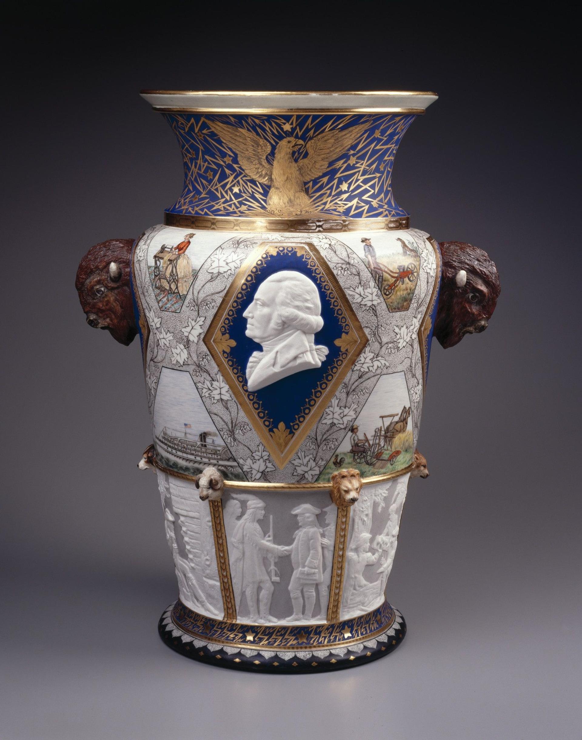 Large, elaborately decorated ceramic vase featuring the face of George Washington, heads of bison, and scenes of American history