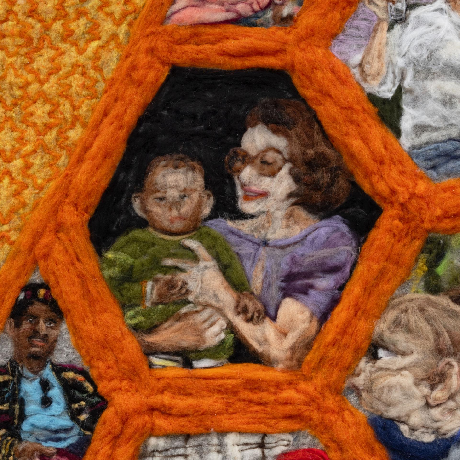 Detail of felted artwork showing an adult and baby framed in an orange hexagon
