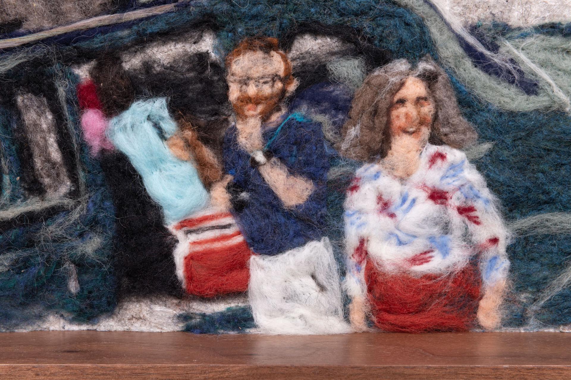 Felted artwork of two people smiling in front of a car