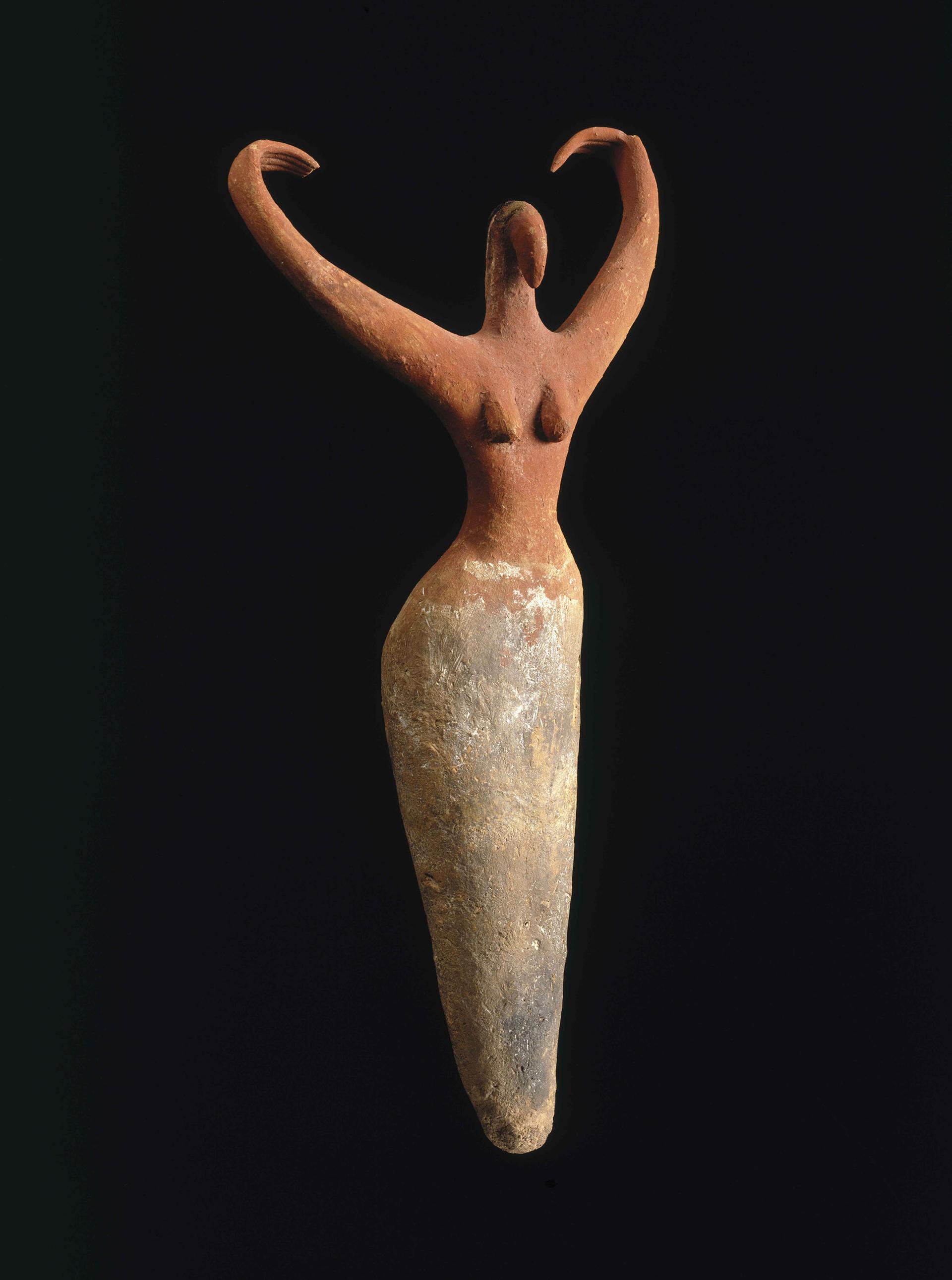 Photograph of a sculpture of a female figure with raised arms