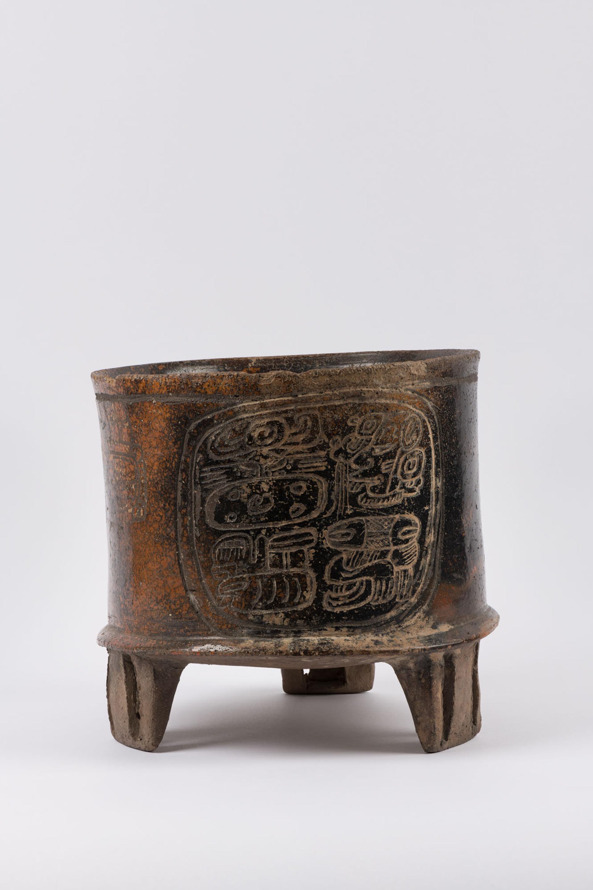 Photo of cup-like bowl, with three legs and engraved design
